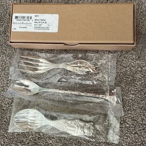 Never opened Reed and Barton silver safari 3 piece baby set.